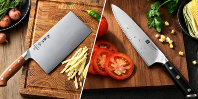 Chinese cleaver and chef knife compared side by side on a kitchen cutting board