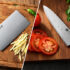 Chinese cleaver and chef knife compared side by side on a kitchen cutting board